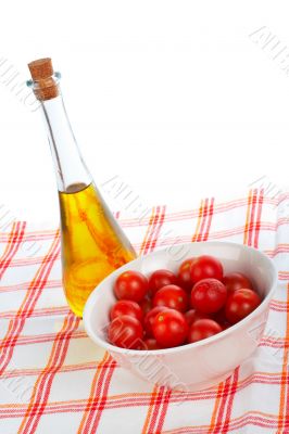 Olive oil bottle and red tomatos cherry