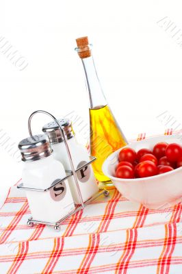 Olive oil bottle and red tomatos