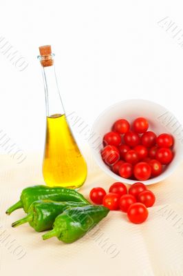 Oil bottle, red tomatos cherry and green pepper