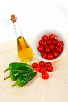 Oil bottle, red tomatos cherry and green pepper