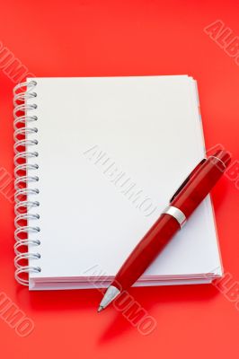 White notebook and pen