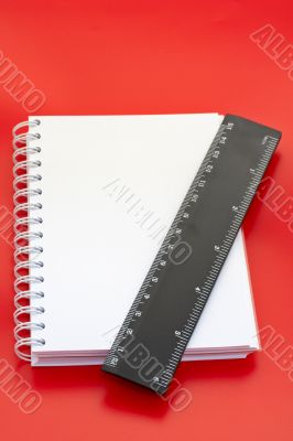 White notebook and measure