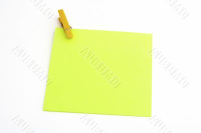 Isolated green paper with yellow clamp