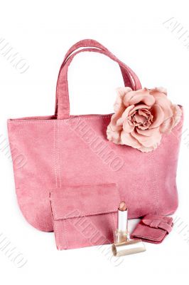 Assortment of pink handbags and lipstick
