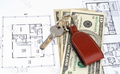 Key and money on home plan