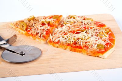 Detail of slices Italian pizza and cutter