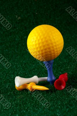 Yellow golfball and tees