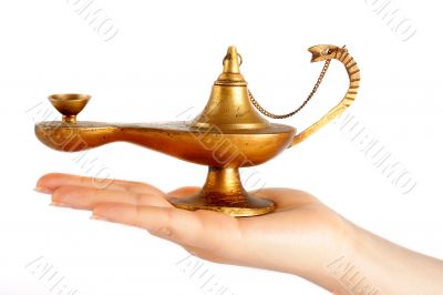 Old brass oil lamp on the hand