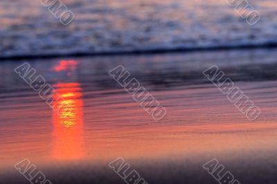 red rays of sunlight on the sand