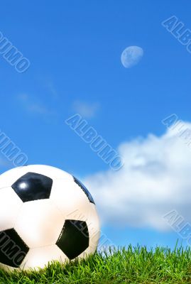 Closeup of a soccerball against a blue sky