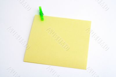 Isolated yellow paper with green clamp