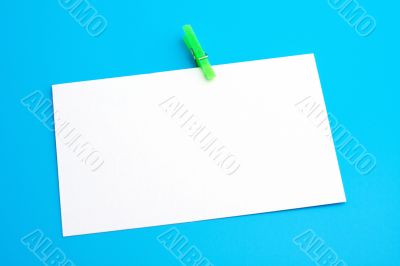 Isolated white paper with green clamp