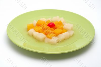Fresh fruit salad on the green plate