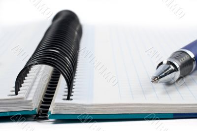 Detail of pen and blank notebook sheet