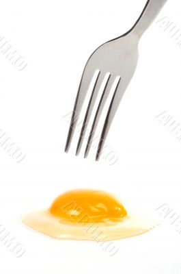 Fork above the raw egg