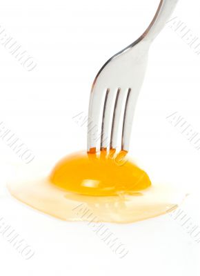 The fork pricking the raw egg