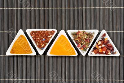 Assortment of spices over a bamboo mat