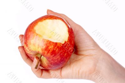 Bitten red apple in hand