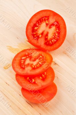 Sliced tomatoes on wood background