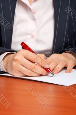 Business woman writing a contract