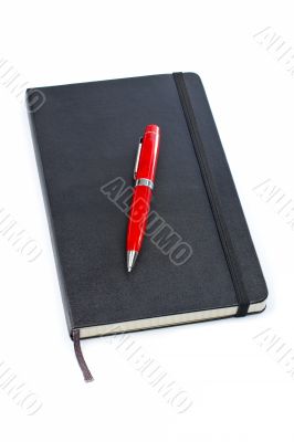 Black notebook and pen