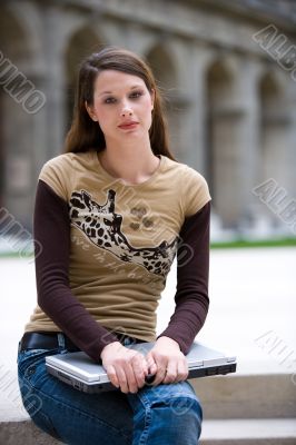 sitting with notebook outdoor
