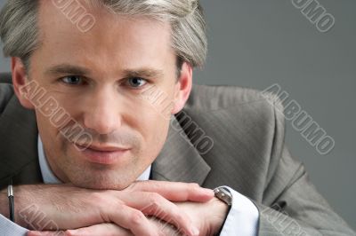 portrait of a smiling businessman with his hands