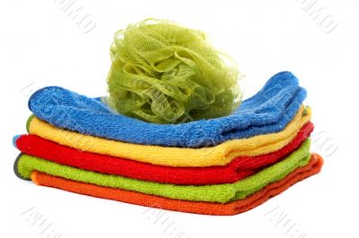 Multicolour towels stacked and body sponge