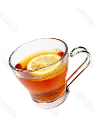 Glass cup of tea with lemon