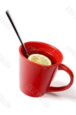 Red cup of tea with lemon and the spoon