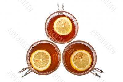 Three glass cups of tea with one slice of lemon