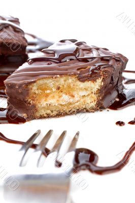 Two chocolate cupcakes with syrup and the fork