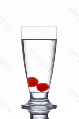 Glass of fresh water with cherries