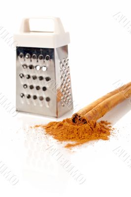 Sticks, powder of cinnamon and grater