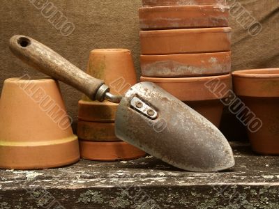 garden trowel leaning on flower pots