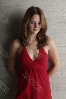 woman leans against a wall