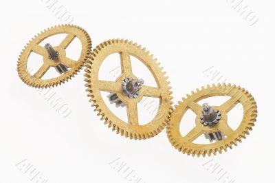 three old gold-coloured cogwheels