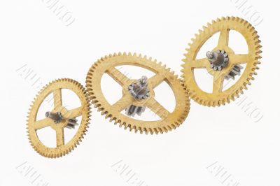 three old gold-coloured little cogwheels