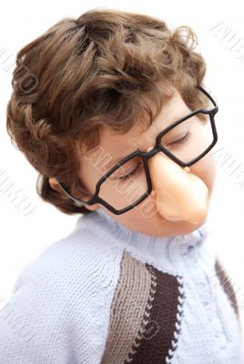 adorable boy with glasses and nose of toy