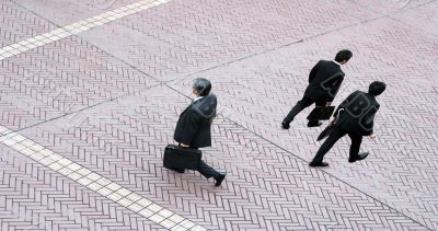 Three business men walking