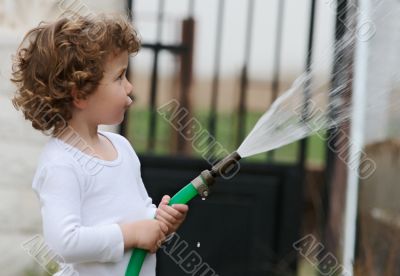 adorable boy watering the plants