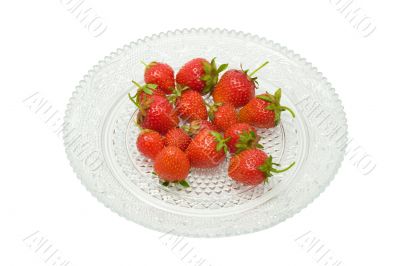 Strawberries on a glass dish, isolated on white