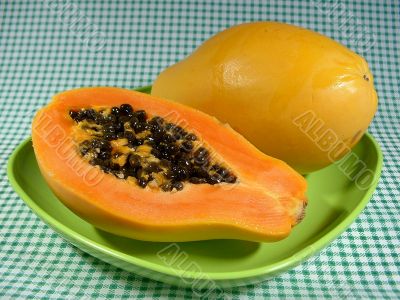 Papayas on green plate