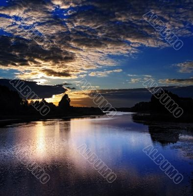 Sunset clouds above lake