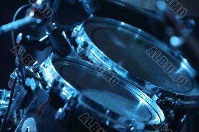 Drum set, lit by blue