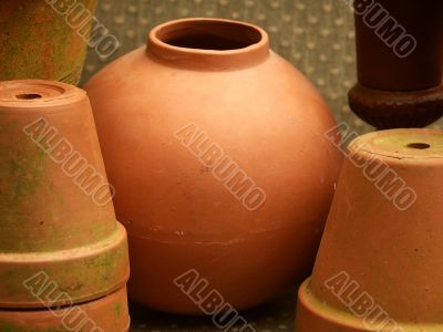 round terra cotta pot among other flowerpots