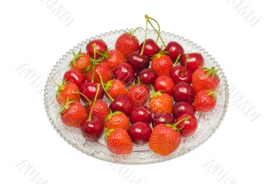 Strawberries, cherries on glass dish, isolated