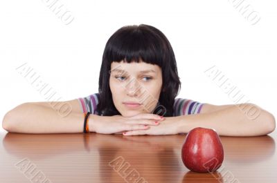 girl watching a red apple
