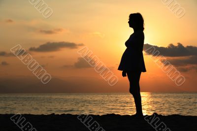 Pregnant woman at sunset