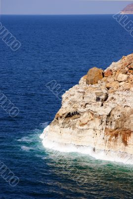 Dead sea with salt caked on rocks